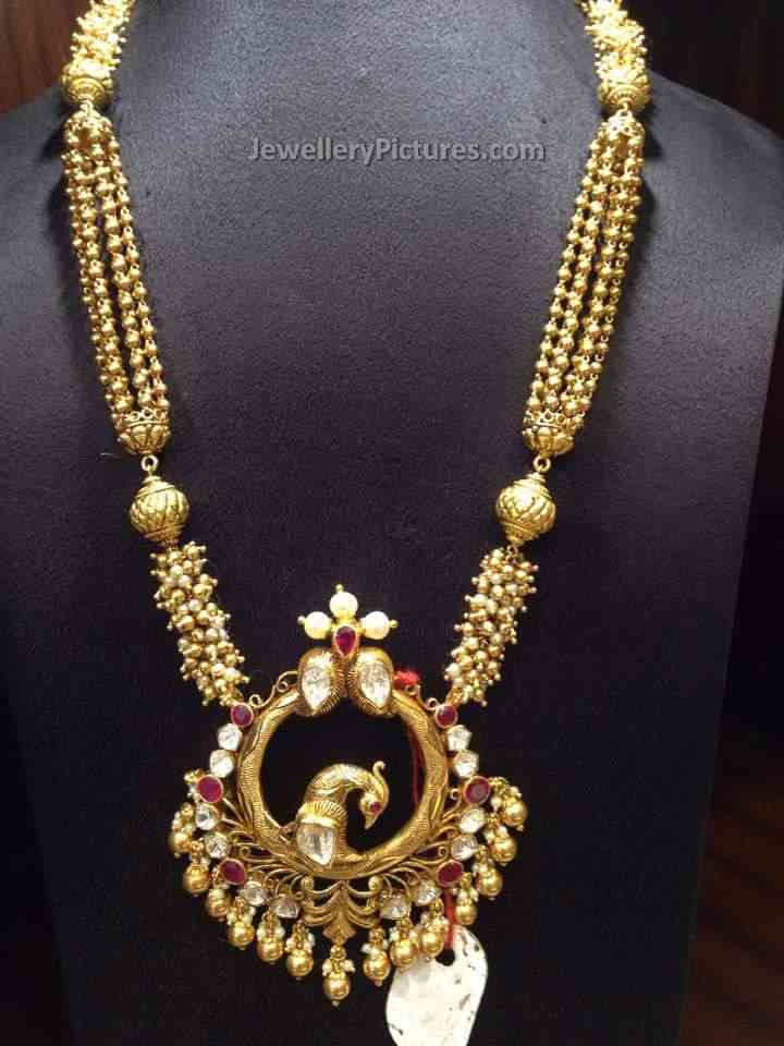 latest long haram designs with chandbali peacock pendant